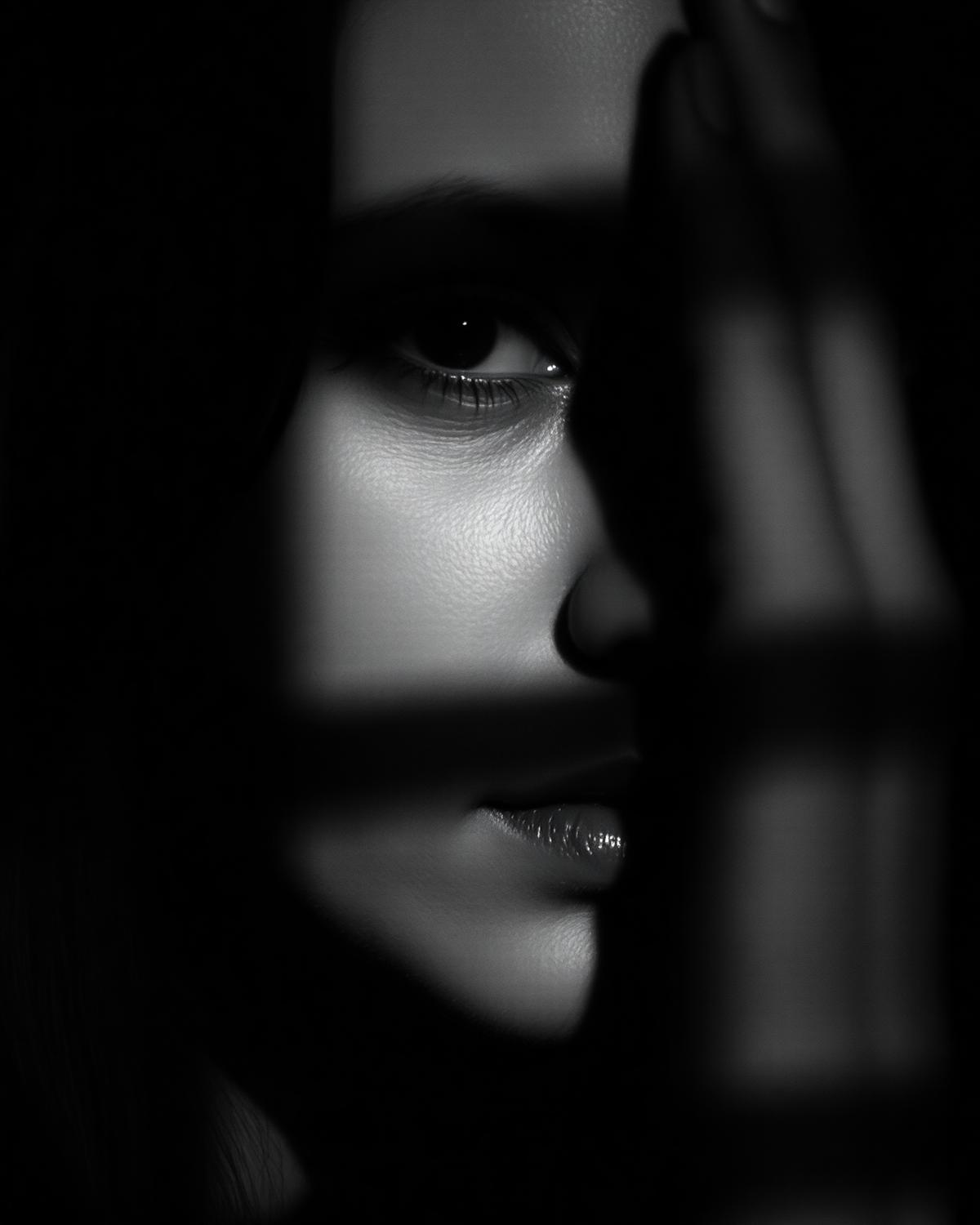 High contrast black and white portrait half in shadow